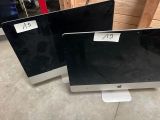 two computer monitors sitting on top of each other in a room