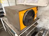 a yellow heater sitting on top of a table in a room
