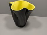 a black and yellow bowl sitting on top of a table