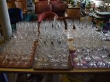 a lot of wine glasses on a table in a room