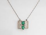 a green stone and diamond pendant on a silver chain