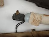 a pipe with a hose attached to it next to a pair of shoes