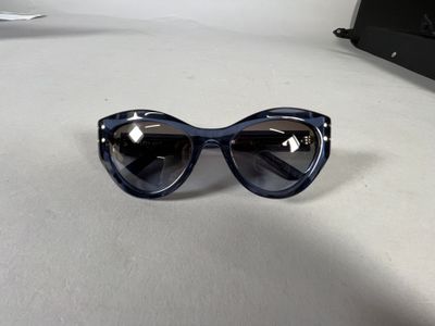 a pair of sunglasses sitting on a table next to a laptop