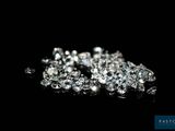 a close up of a pile of diamonds on a black surface