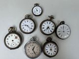 many different types of pocket watches displayed on a wall