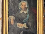 painting of a woman in a blue bonnet sitting in front of a bookshelf