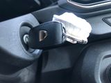 a car door handle with a cell phone in it