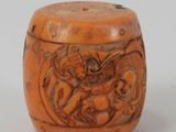 a small wooden box with carvings of animals on it