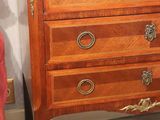 a marble top chest of drawers on display in a room