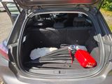the trunk of a car with a fire extinguisor in the trunk
