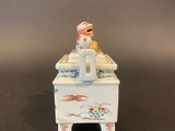 a small figurine of a dog sitting on a table