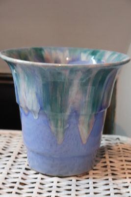 a blue bowl sitting on top of a white table