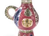 a red vase with a blue and green design on it