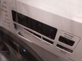 a washing machine that is wrapped in plastic on the floor