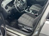 the interior of a car with the door open and the driver ' s seat up