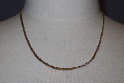 a close up of a mannequin torso with a chain on it