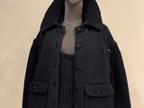 an image of a mannequin wearing a black jacket and skirt