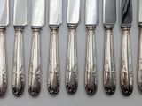 six knives and six knives on a table