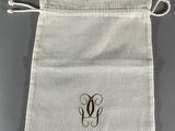 a white bag with a monogrammed initial on it