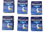 Quatre boîtes de Nownut sont posées les unes à côté des autres sur une surface blanche.