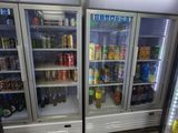 deux réfrigérateurs contenant des boissons dans un magasin