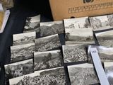 a lot of old black and white photos on a table