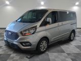 the silver van is parked in a room with a checkered floor