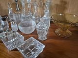 a lot of glass items sitting on a wooden table