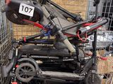 a pile of scooters in a cage with a number plate on it