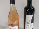 two bottles of wine sitting next to each other on a table