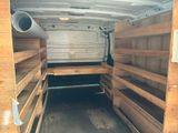 a picture of the inside of a van with wooden shelves