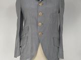 grey jacket on a mannequin stand with a white background