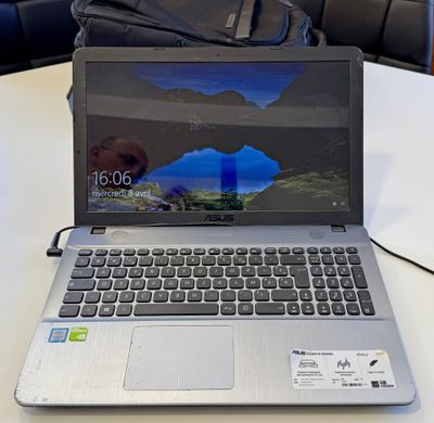 a laptop that is sitting on a table with a bag