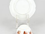 a white plate and a white plate on a stand