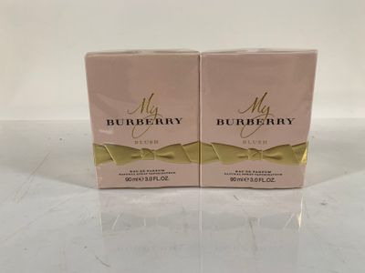 two boxes of burberry perfume on a white surface