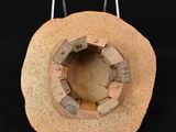 a small sculpture of a rock with a hole in it