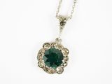 a close up of a necklace with a green stone on it