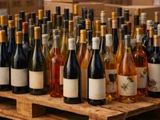 many bottles of wine sitting on a wooden pallet