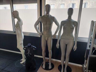 three mannequins that are standing in front of a window