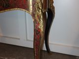 a black and gold table with a red and gold top