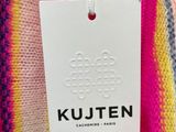 a pink and yellow striped sweater hanging from a hanger