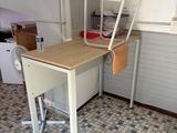 une photo d'une cuisine avec un bureau et une échelle