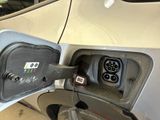 an electric car being charged at a gas station