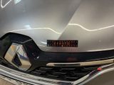 a close up of the front of a car with a number plate on it