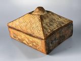 an old wooden box sitting on top of a white surface