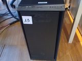 a computer that is sitting on the floor in front of a chair
