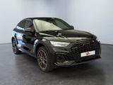 a black car parked in a room with a white wall