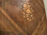 a wooden table with a floral design on it