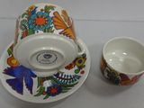 a cup and saucer sitting next to each other on a table