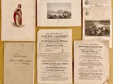 some old papers are laying on a table with a lot of other papers